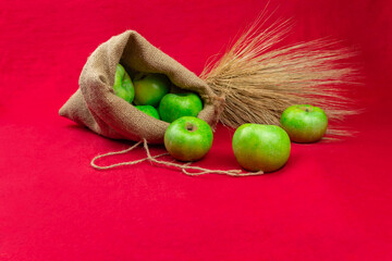 Green apples on a red background