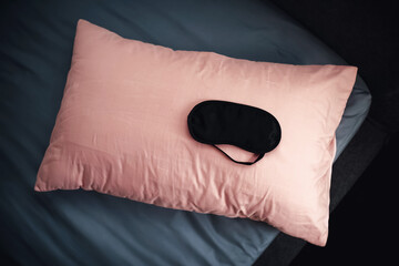 sleeping mask on a pink pillow