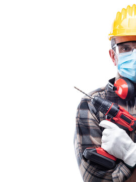 Carpenter worker isolated on white background, wears helmet, goggles, leather gloves, earmuffs and surgical mask to prevent coronavirus infection. Preventing Pandemic Covid-19 at the workplace.