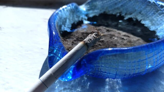 Home fire. The wind blows a smoking cigarette out of the ashtray. Dangerous situation. 