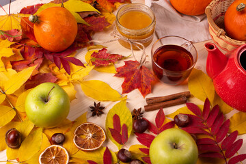 Naklejka na ściany i meble autumn leaves and tea