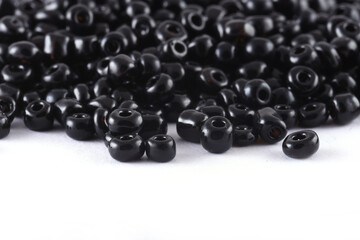 Close up of Black Beads on the white background. Background or texture of beads. macro,It is used in finishing fashion clothes. make bead necklace or string of beads for woman of fashion.