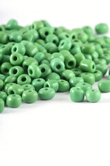 Close up of green Beads on the white background. Background or texture of beads. macro,It is used in finishing fashion clothes. make bead necklace or string of beads for woman of fashion.