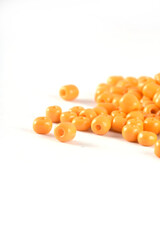 Close up of yellow Beads on the white background. Background or texture of beads. macro,It is used in finishing fashion clothes. make bead necklace or string of beads for woman of fashion.