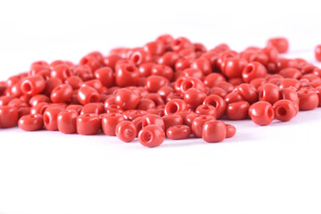 Close up of red Beads on the white background. Background or texture of beads. macro,It is used in finishing fashion clothes. make bead necklace or string of beads for woman of fashion