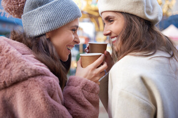 Close up of women drinking mulled wine outdoors