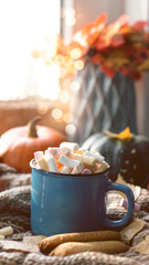 Obraz na płótnie Canvas Autumn background with dry leaves, blue cup of coffee. Knitted background, pumpkins, October, November. Autumnal atmosphere. Autumn season.