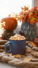 Obraz na płótnie Canvas Autumn background with dry leaves, blue cup of coffee. Knitted background, pumpkins, October, November. Autumnal atmosphere. Autumn season.