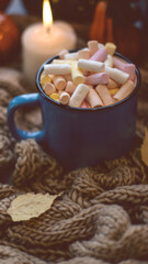Autumn background with dry leaves, blue cup of coffee. Knitted background, pumpkins, October, November. Autumnal atmosphere. Autumn season.