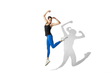 Fototapeta na wymiar High up. Beautiful young female athlete stretching, training on white studio background, portrait with shadows. Sportive fit model in motion and action. Flexibility, healthy lifestyle, style concept.