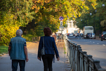 people walk in the autumn evening in sunny weather on the street in Pushkin