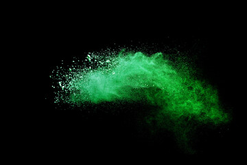 Green powder explosion on black background.