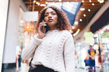 Beautiful dark skinned girl woman walking outdoors having mobile phone conversation via...