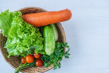 Mixed vegetables In a wooden basket on a white background