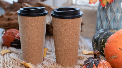 Autumn background with dry leaves, blue cup of coffee. Knitted background, pumpkins, October, November. Autumnal atmosphere. Autumn season.