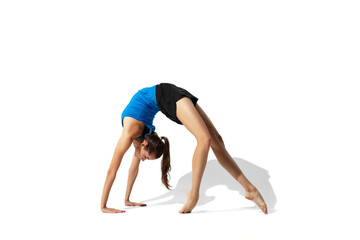 Fototapeta na wymiar Split. Beautiful young female athlete stretching, training on white studio background, portrait with shadows. Sportive fit model in motion and action. Flexibility, healthy lifestyle, style concept.