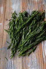 Rosemary branches laying on light wooden background