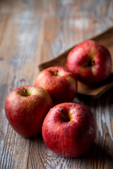 Fototapeta na wymiar Red ruddy organic apples on rustic table close up