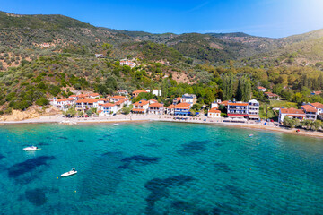 Aerial view of the little fishing village Platanias, South Pelion, Greece, with turquoise sea and red roofed houses