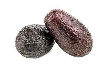 two brown avocado on white