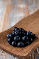 Close up of big blueberries in a wooden spoon
