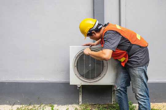 The Technician Is Fixing The Air Conditioner.