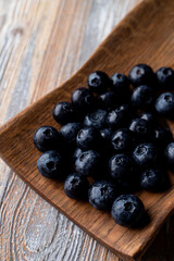 Ripe blueberries on wooden background, close up, appetizing advertisement and catalog shot