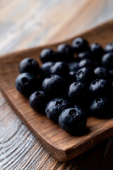 Ripe blueberries on wooden background, close up, appetizing advertisement and catalog shot