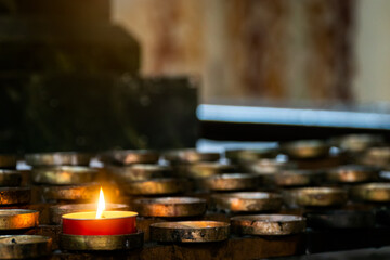 Blurred architecture background of church interior inside old cathedral catholic holy pray god jesus religion with candles 