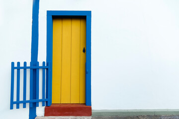 simple house facade with yellow door