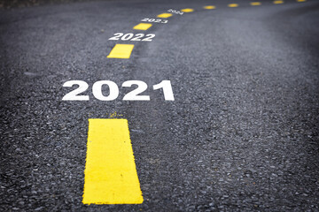 Number of 2021 to 2024 on asphalt road surface with marking lines, happy new year concept