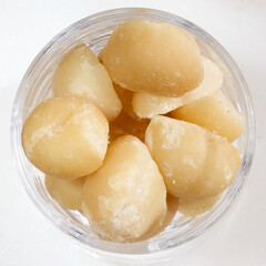 Macadamia nuts in a glass dish.