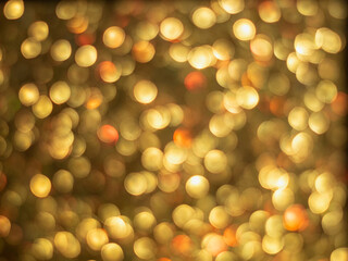 Gold bokeh holiday textured glitter background. Blurred abstract holiday background.