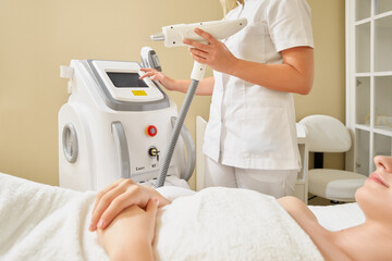 Cosmetology. Beautiful Woman Receiving Laser Hair Removal Procedure At Beauty Salon. High Resolution.