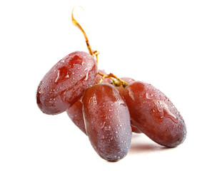 Red juicy grapes are isolated on a white background.