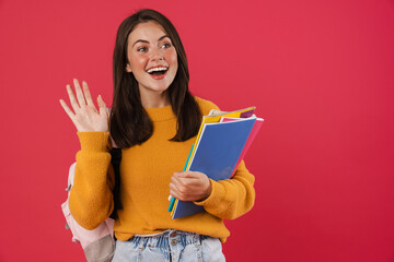 Image of happy beautiful student girl posing with exercise books