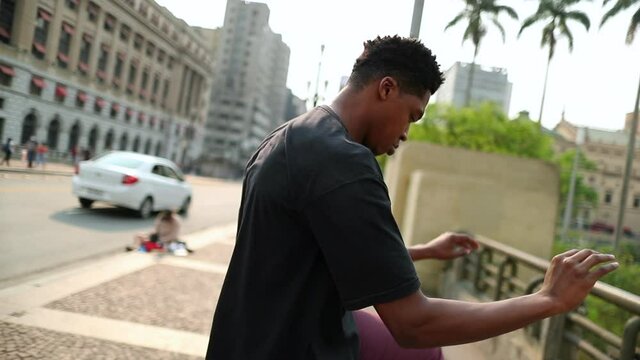 African man dancing in downtown city doing freestyle urban dance