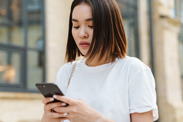 Young beautiful asian woman using phone