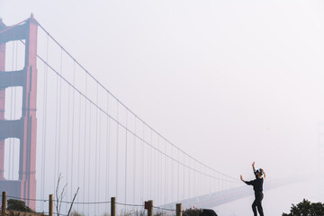 Anonymous female using VR headset near bridge