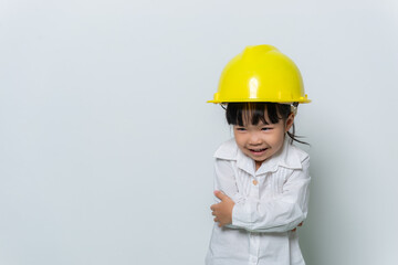 Portrait of cute asian little girl in engineer uniform and helmet on white background