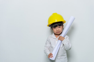 Portrait of cute asian little girl in engineer uniform and helmet on white background