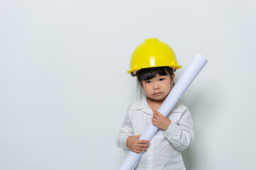 Portrait of cute asian little girl in engineer uniform and helmet on white background