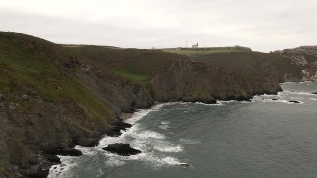 Rugged coast terrain of Asturias in Northern Spain with waves crashing on shore