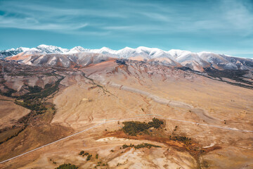 Fototapeta na wymiar Colourful pink, orange, snow autumn mountains landscape aerial drone view