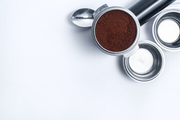 Espresso holder and replaceable coffee filters. The horn from the coffee machine on a white...