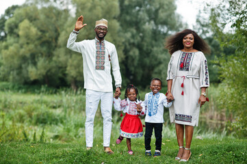 Naklejka na ściany i meble African family in traditional clothes at park.