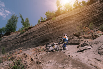 Rider climbing sand mountain on  off-road cross motorcycle