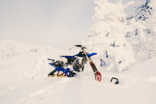 snowbike on snow powder covered mountain slop. Outdoor activity in winter day