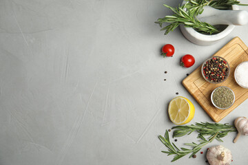 Flat lay composition with ingredients for cooking on grey table. Space for text