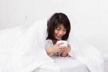 Emotion asian woman in pajamas on bed in bedroom at home.